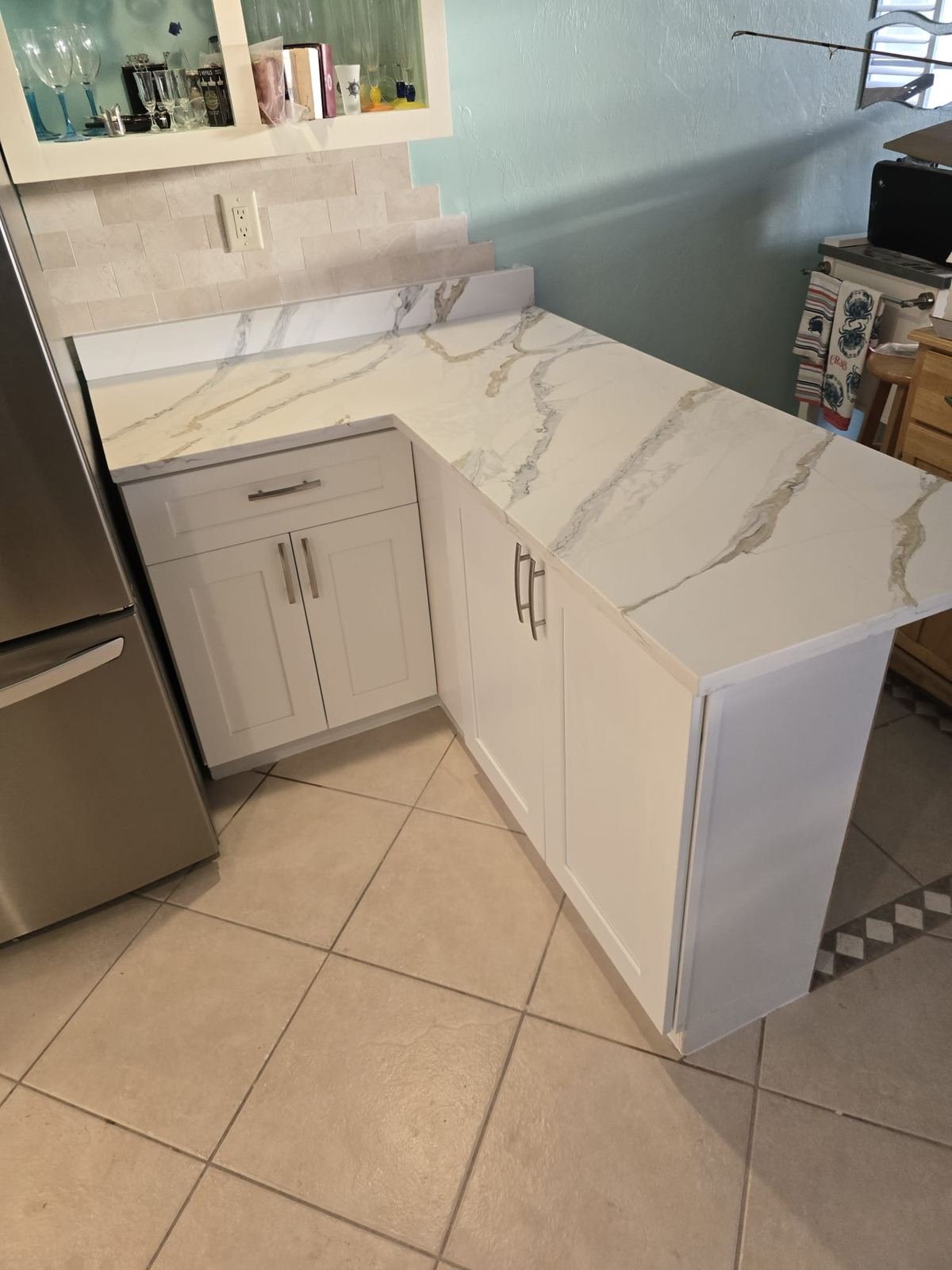 Marble look quartz countertop installation with waterfall edge Fort Myers FL