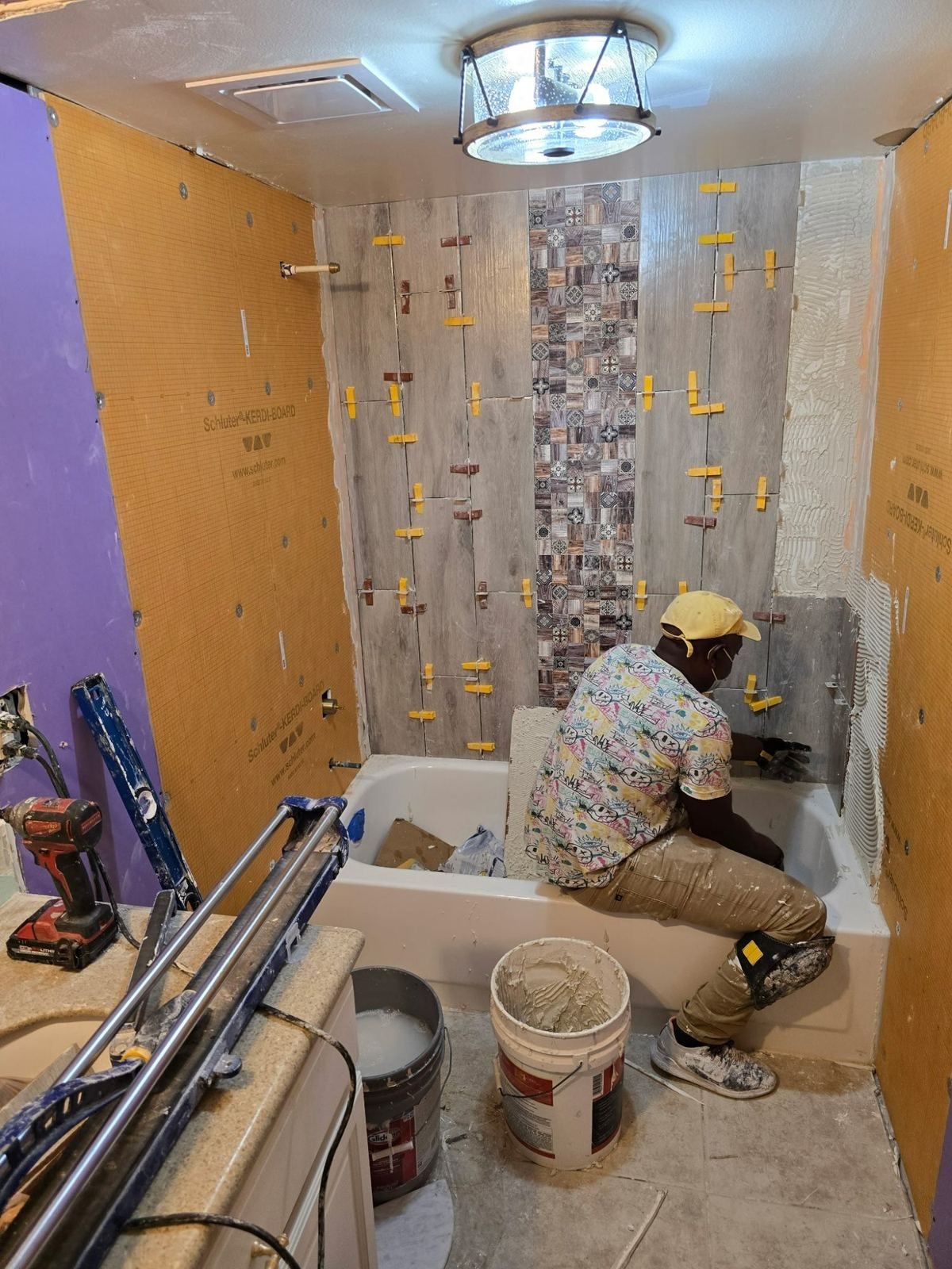 Master bathroom before renovation with old tile and tub surround Southwest Florida
