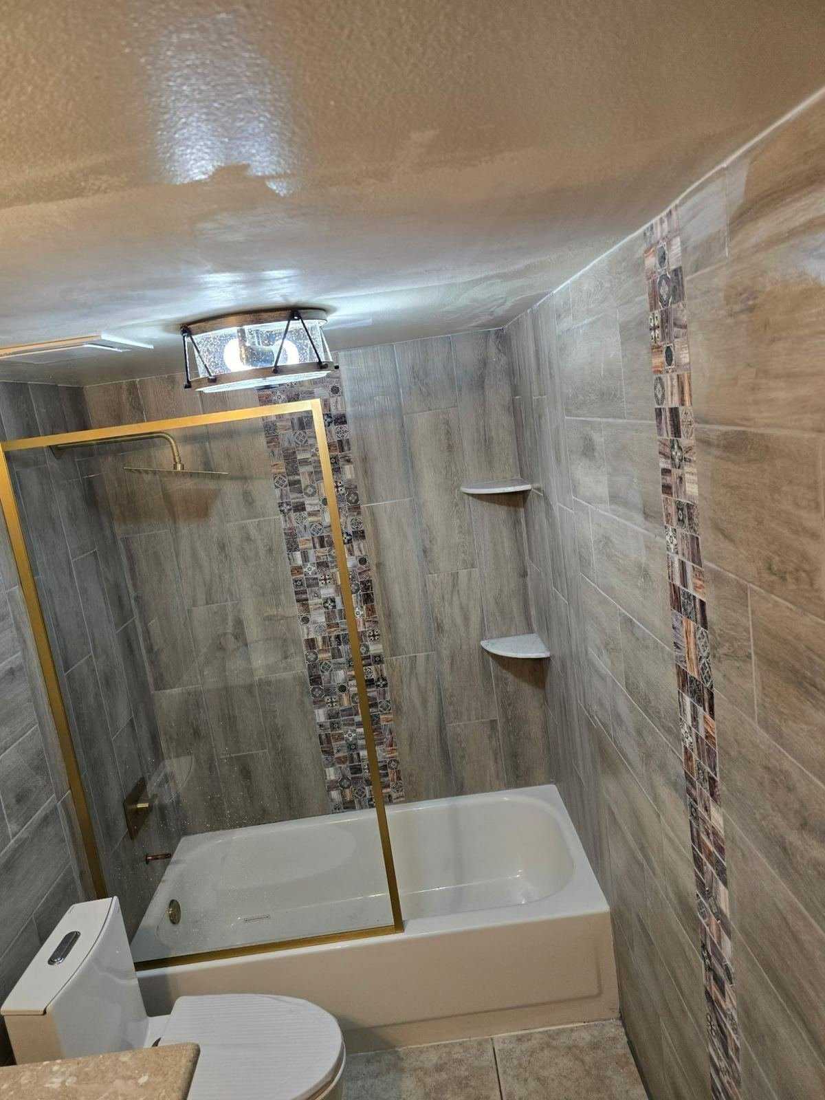 Completed master bathroom remodel with soaking tub stone tile and LED mirror Southwest Florida