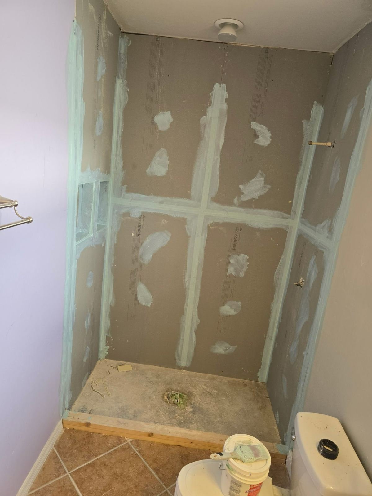 Shower before remodel with exposed drywall and cement board Cape Coral FL