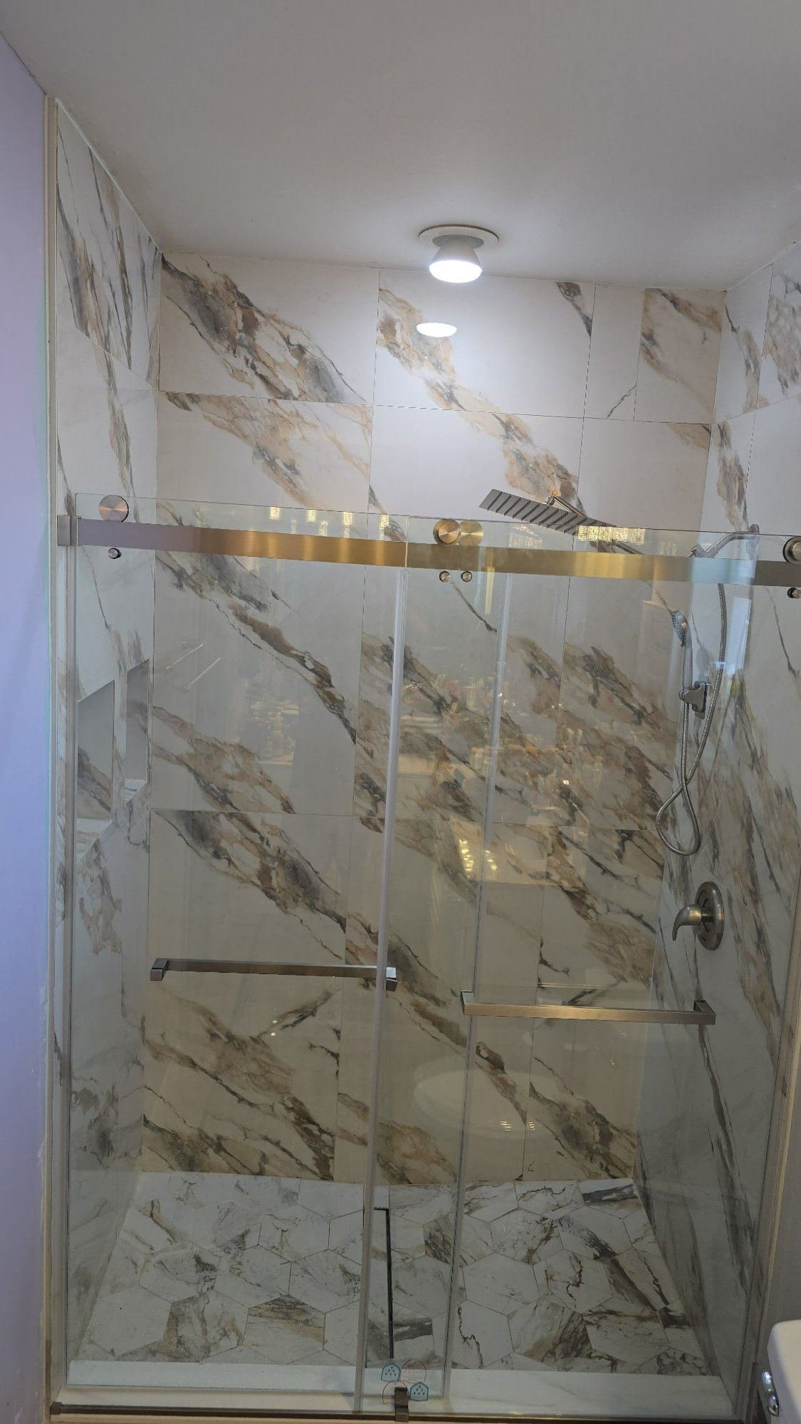 Completed shower remodel with marble tile and glass door Cape Coral FL